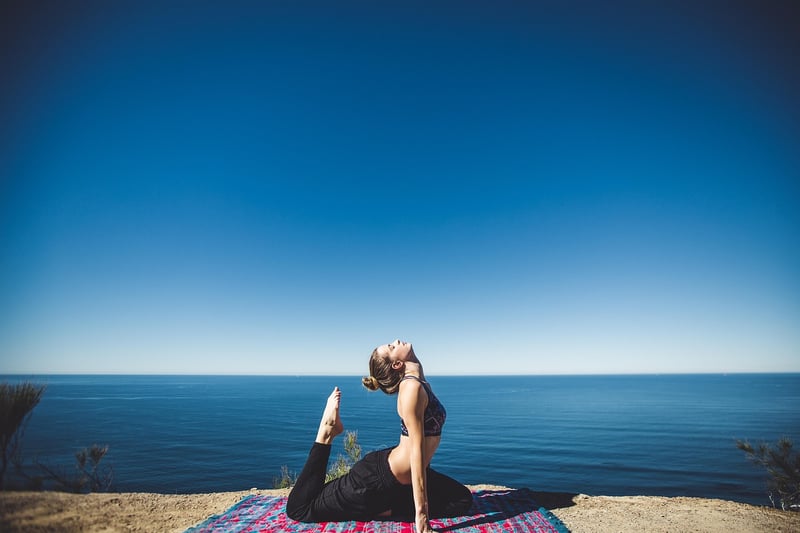 Woman practicing restorative yoga in nature